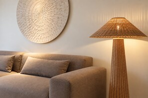 A modern living room with a sofa and a floor lamp.