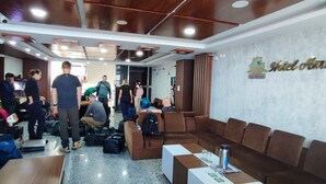 A hotel lobby with seating areas, a reception desk, and a sign indicating the hotel name. - Hotel Ambrosia (Bhimeshwar)