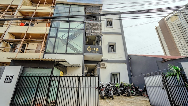 A multi-story building with a gated entrance, a balcony, and a sign indicating it is a living space. - CQA Living By ARBA (Jakarta)