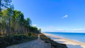 A beach path leading to the ocean, surrounded by dense forest. - The Corner House -  a house that sleeps 10 guests  in 4 bedrooms (Hopeman)