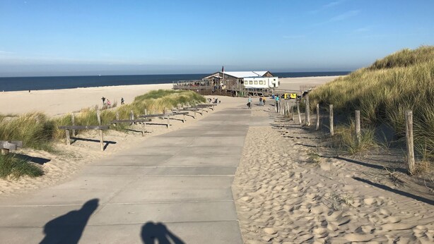 A beachside walkway leading to a building with a beach view. - Sunny house close to the dunes and the sea. Families with children and dogs. (Warmenhuizen)