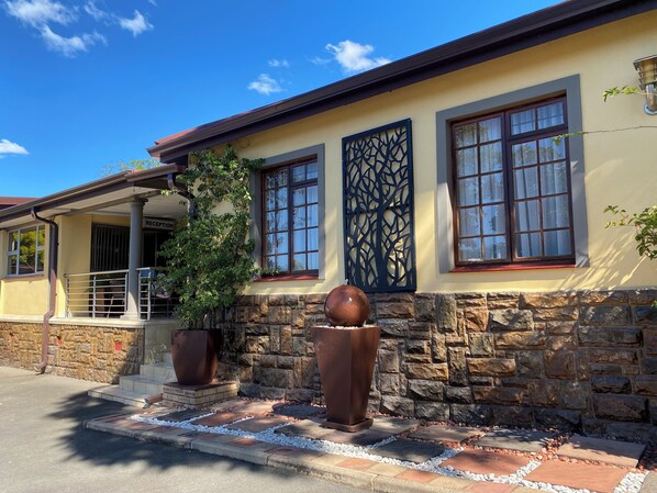 A building with a reception area, stone facade, and large windows.