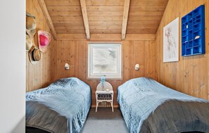 A cabin room with two beds, a window, a blue shelf, and a wall-mounted light fixture. - Lovely home in Hvide Sande with sauna (Hvide Sande)