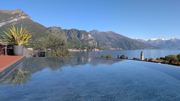 An infinity pool with a mountain backdrop and a clear sky. - Villa Cosima in Bellagio With Private Pool by Rent all Como (Bellagio)