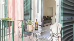 An outdoor patio with a table, chairs, a bottle of wine, and a potted plant. - Cernobbio Dream Suites by Rent all Como (Cernobbio)