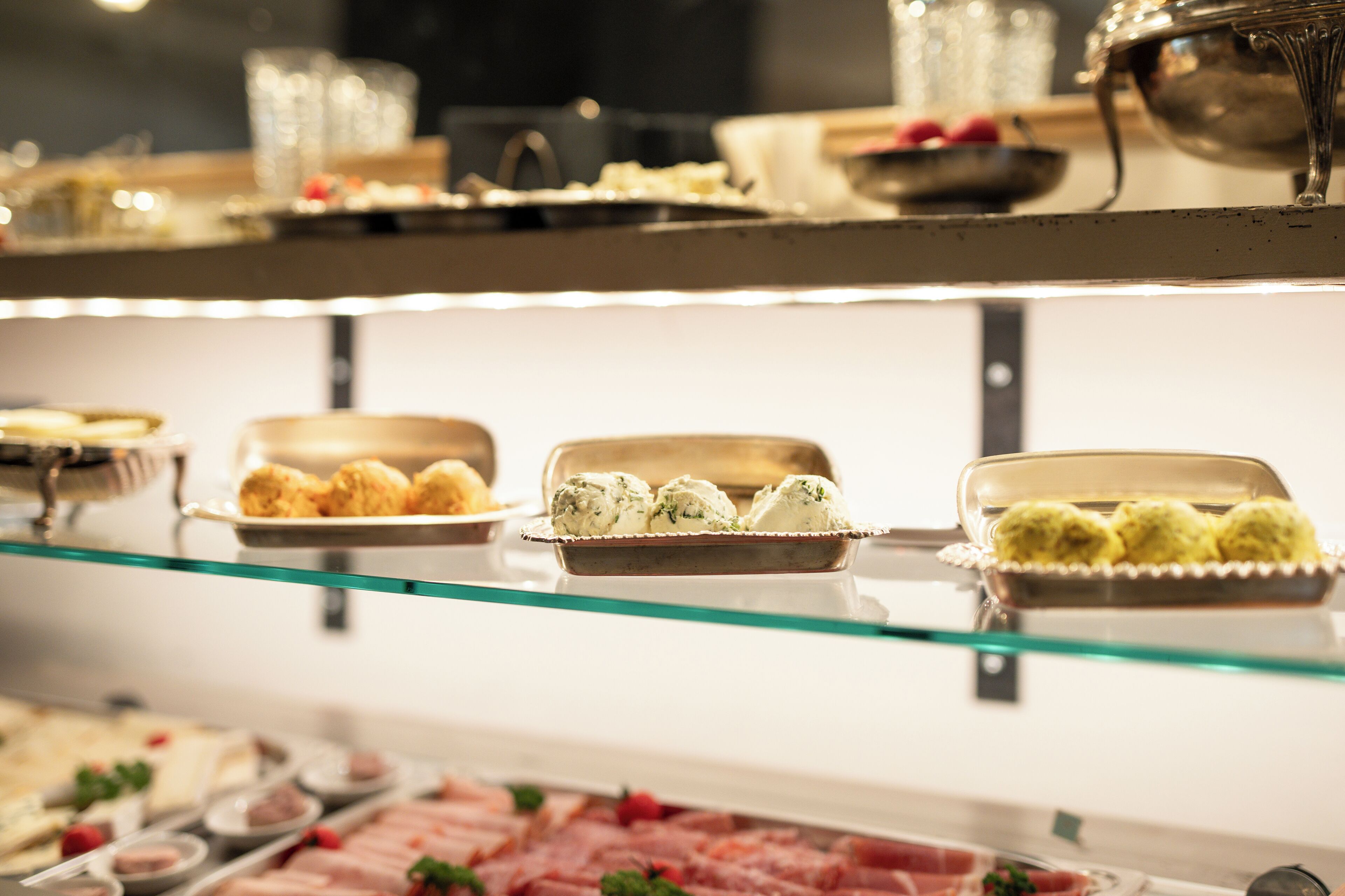 A buffet with various food items including pastries, meats, and desserts.