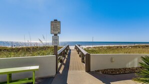 A beach access walkway with a private access sign, a bench, and a clear view of the ocean. - Cozy Pet Friendly Beachfront Retreat On Top Floor (Orange Beach)