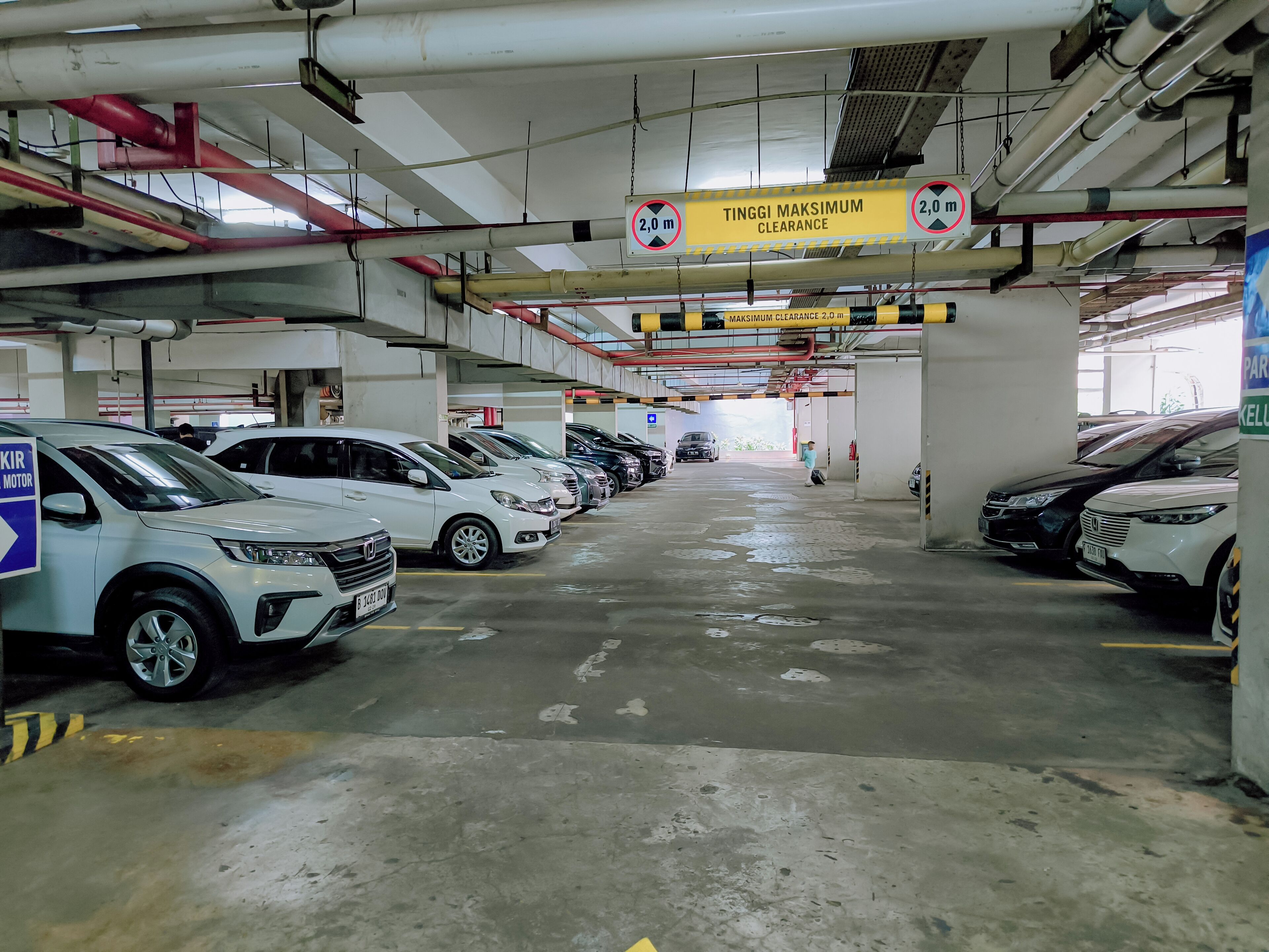 A multi-level parking garage with several cars parked.