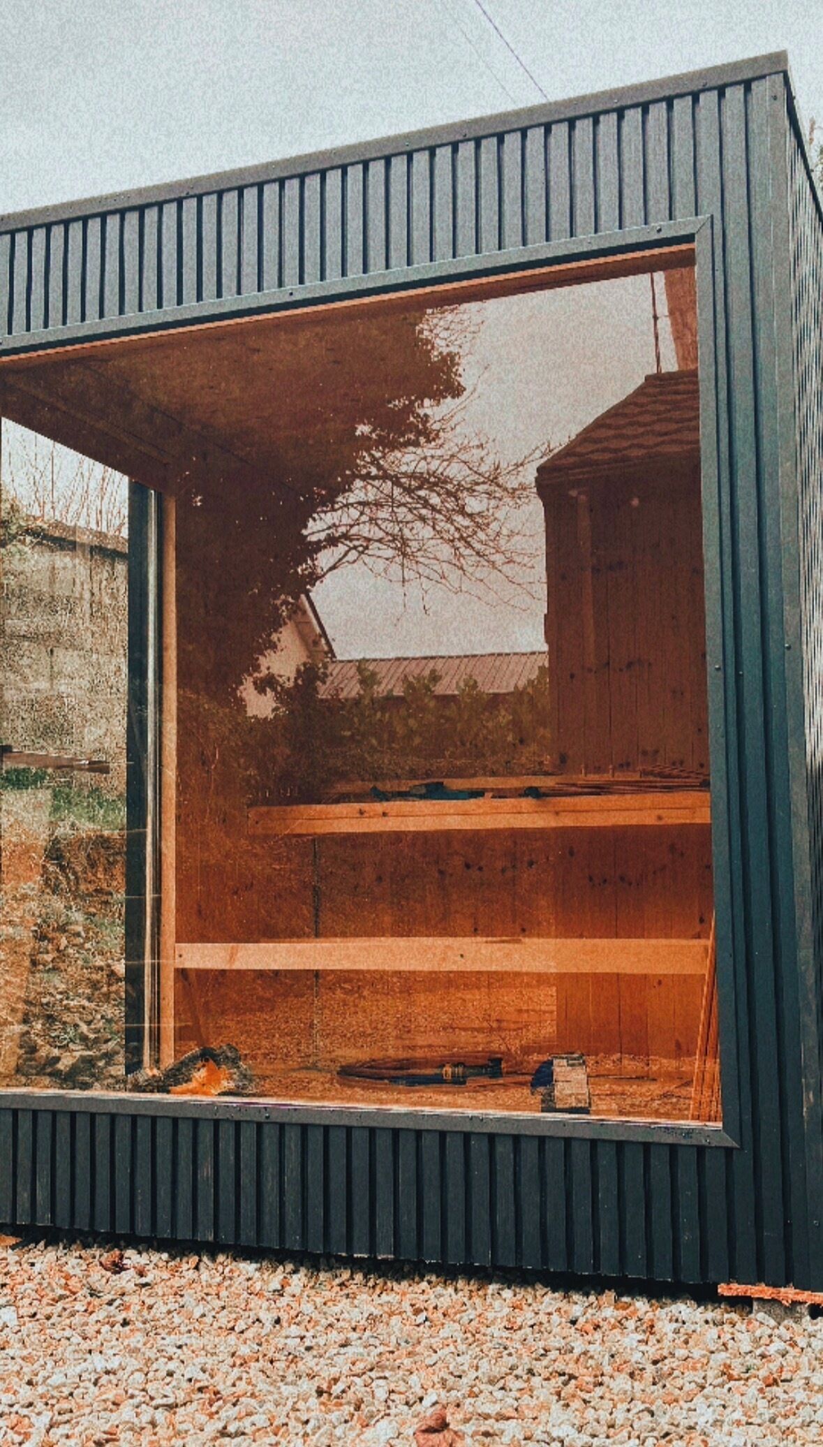Un bâtiment moderne doté d’une grande fenêtre et d’un intérieur en bois.