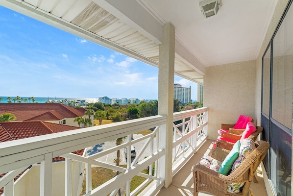 Enjoy breathtaking ocean views from this spacious balcony with a cityscape in the distance.