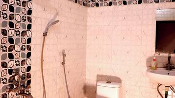 Deluxe Room | Bathroom | Shower, slippers, towels, soap