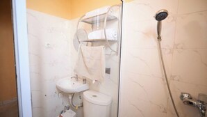 A bathroom with a toilet, sink, and shower. - amp lodge (Kumasi)