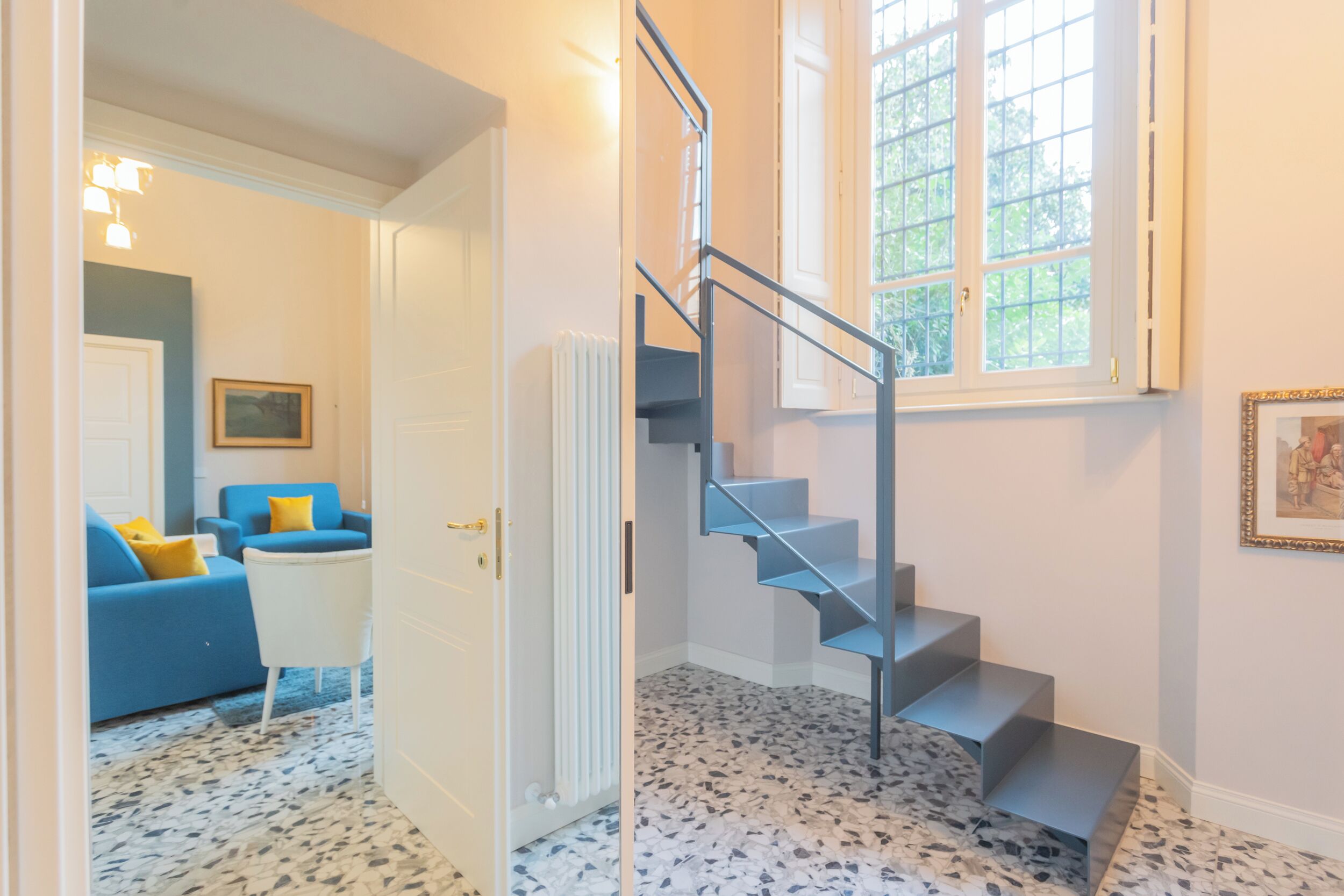 A staircase with a metal railing leading to a landing.