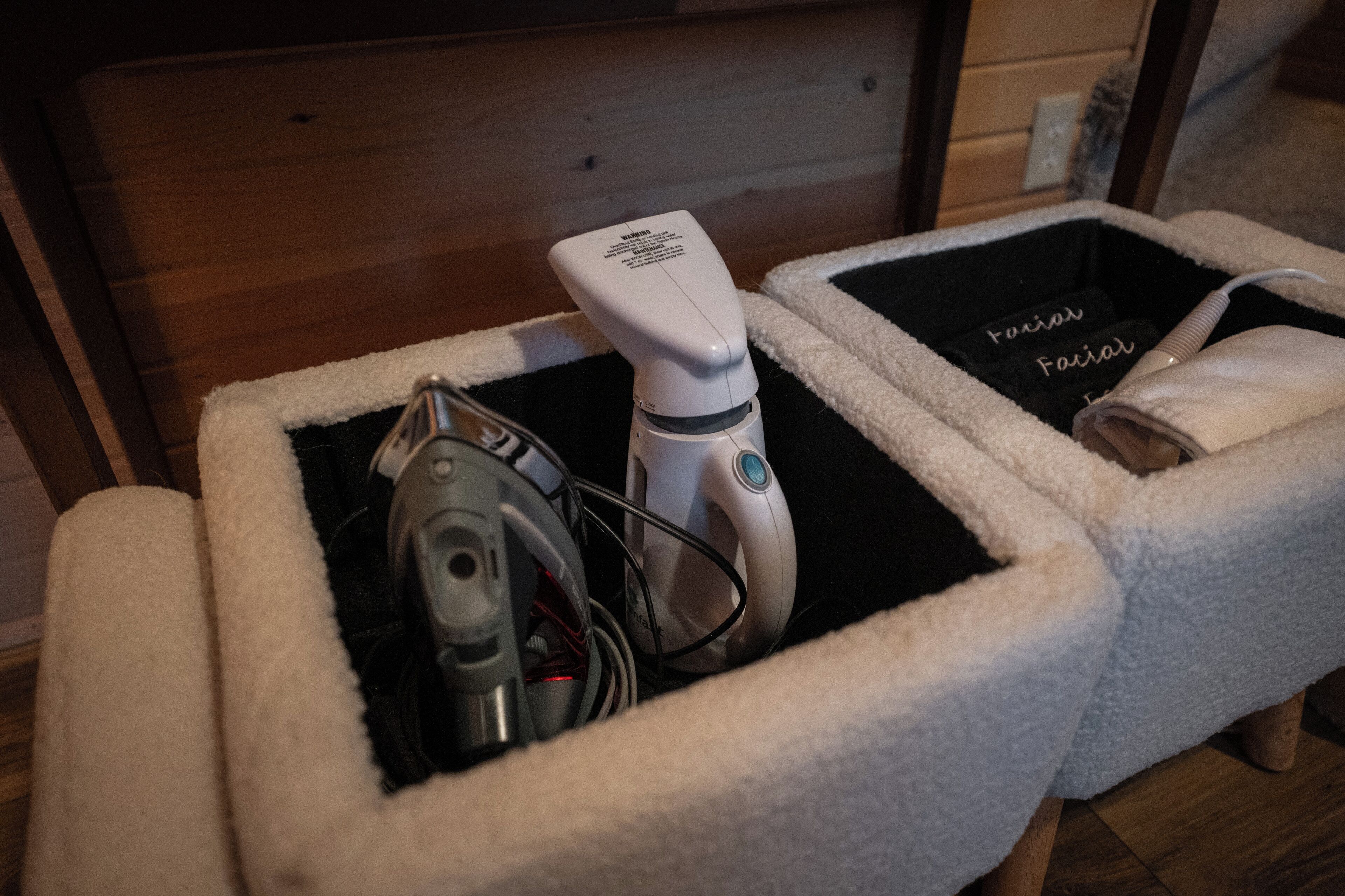 A pet bed with a built-in heating pad and a water bottle.