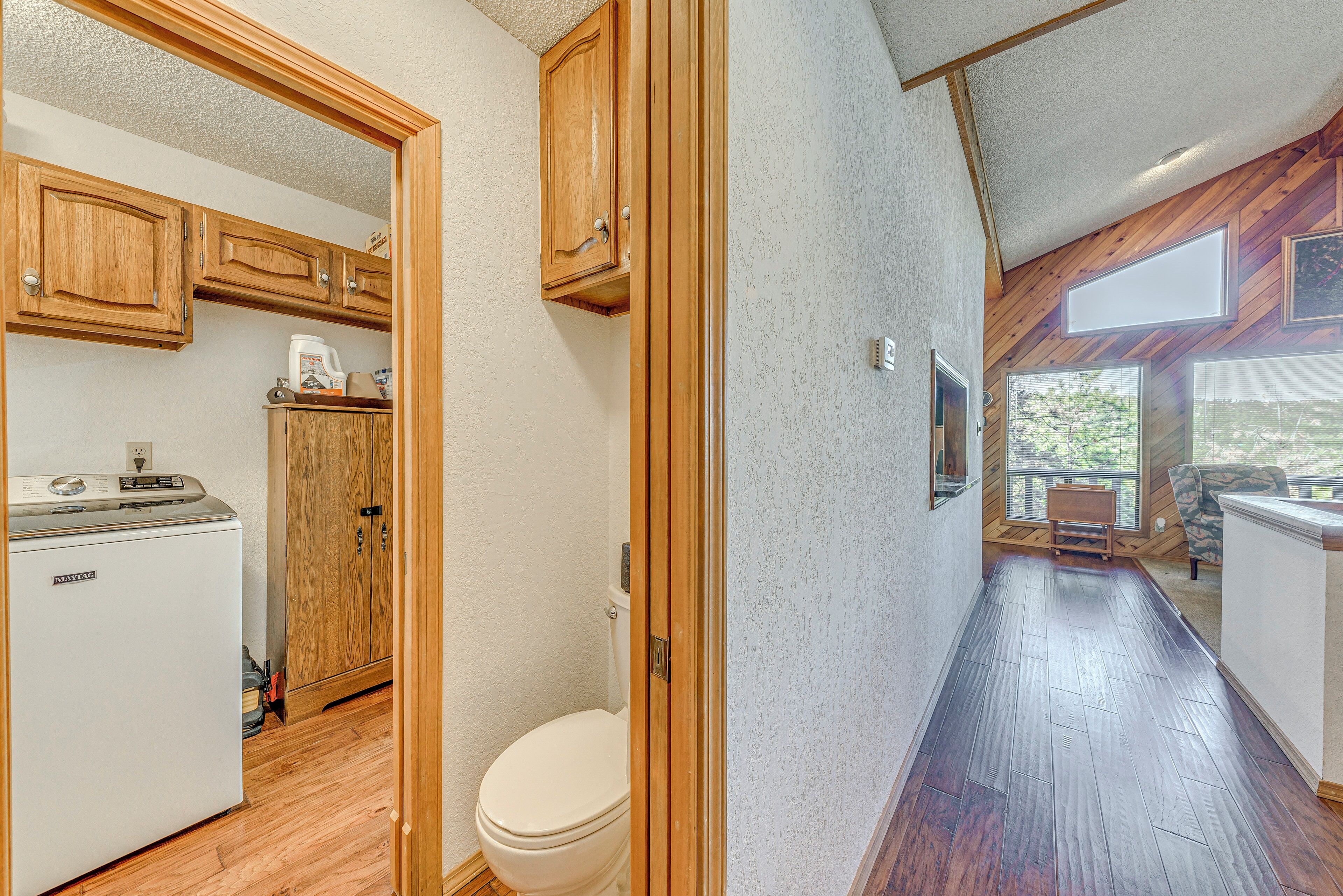 A compact kitchen with wooden cabinets and a white refrigerator.