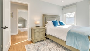 A bedroom with a bed, nightstand, and a ceiling fan. - 2 Mi to Northwestern: Updated Home w/ Game Room! (Evanston)