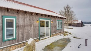 A rustic wooden building with a metal roof and a stone foundation. - Ride From Your Door: Cabin w/ Vast Trail Access! (Hardwick)