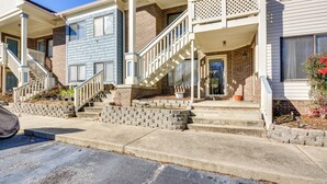 A residential building with a covered porch, a staircase leading to the entrance, and a brick foundation. - 15 Mi to Greensboro: Archdale Condo w/ Fireplace (High Point)