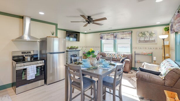 A modern kitchen with a stove, oven, and refrigerator. There is a dining table with chairs and a ceiling fan. - 9 Mi to Lake Carlsbad: Pet-friendly Apt (Carlsbad)