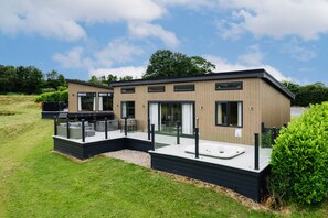 A modern two-story house with a patio area, a hot tub, and a deck. - Mallard s Rest - Countryside Hot Tub (Narberth)