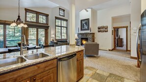 A spacious kitchen with granite countertops, stainless steel appliances, and a large island with a dishwasher. - Spacious Upstairs Townhome With Private Garage 2 Bedroom Condo (Breckenridge)
