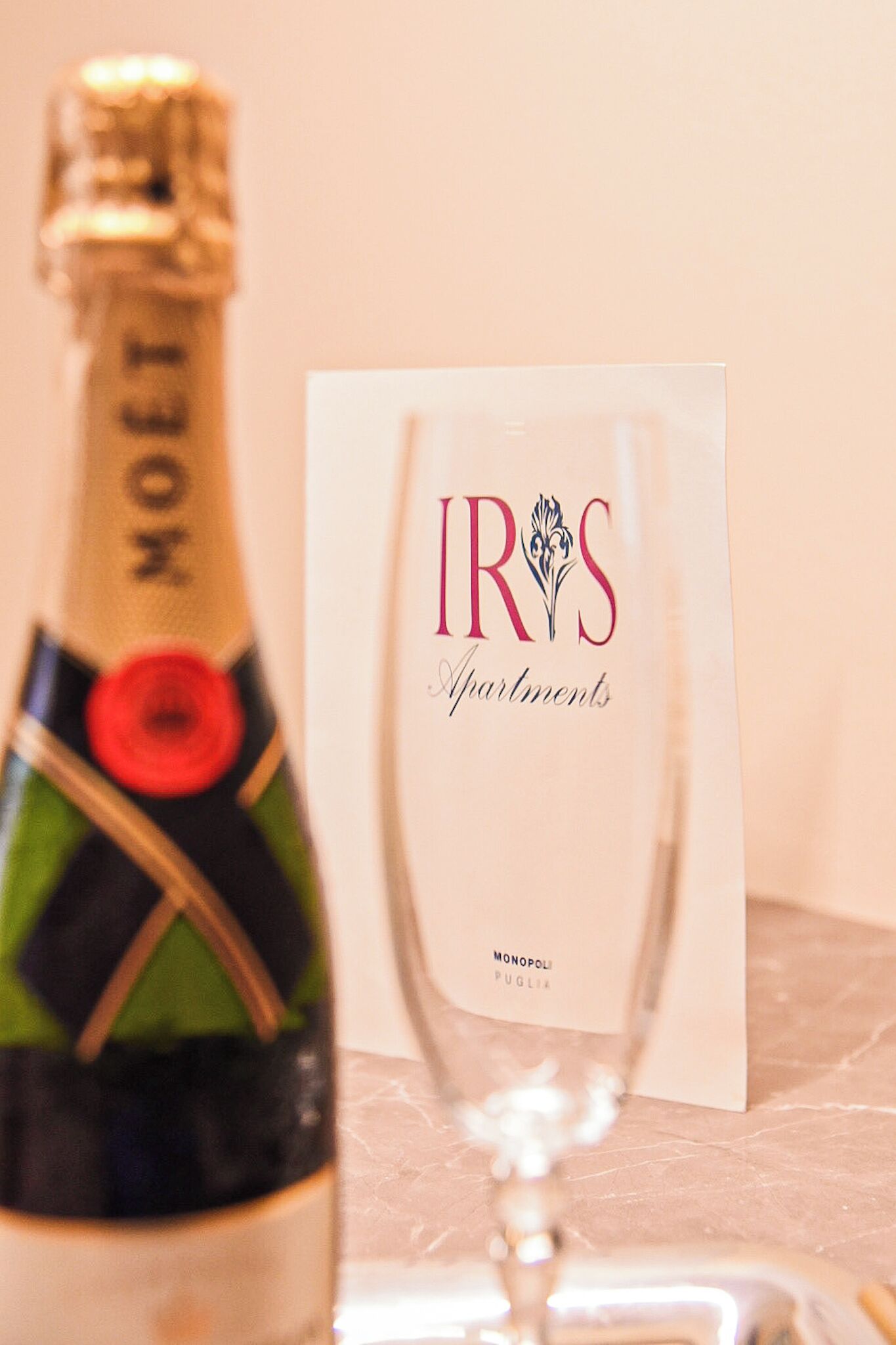 A bottle of Moët champagne and a card for IRYS Apartments.
