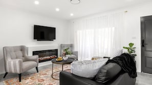 Smart TV, fireplace, books, stereo