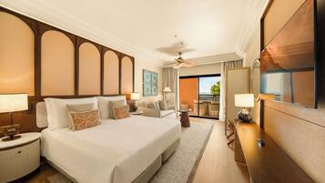 A hotel room with a large bed, bedside tables, a desk, and a view of the outdoors.