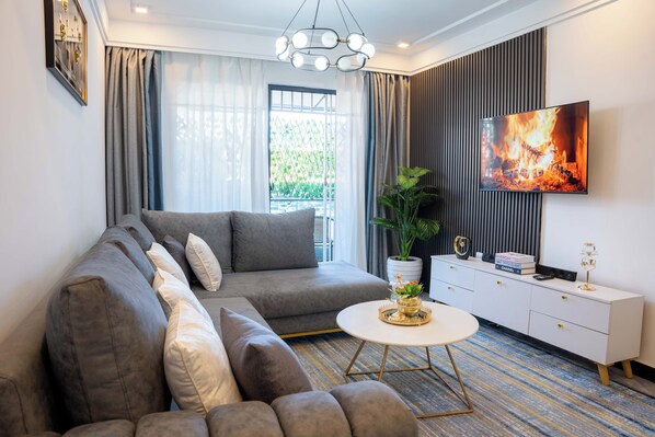 Apartamento superior, 1 quarto, banheiro privativo, vista para a cidade | Área de estar
