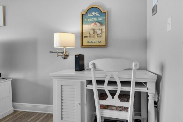 A white desk with a lamp, a framed sign, and a chair. - 🌴Santa Rosa Dunes 825: 2BR, 2.5BA Condo w/Sound Views🌴 (Pensacola Beach)