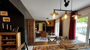 A cozy dining area with a wooden table, chairs, and a patterned rug.