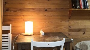 A wooden-paneled room with a table, a chair, and a lamp. - l'Atelier USU15 downtown Grenoble (Grenoble)