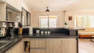 Coffee/tea maker, fridge, microwave, oven