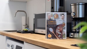 A kitchen counter with a coffee maker, a microwave, and a box of natural spices. - Schöne Apartments in Bad Honnef (Bad Honnef)