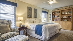 A bedroom with a bed, a chair, a bookshelf, and a ceiling fan. - 13419 - 19 Aldaya Lane (Hot Springs)