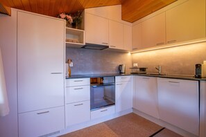 Basic Apartment | Private kitchen | Cookware/dishes/utensils, freezer
