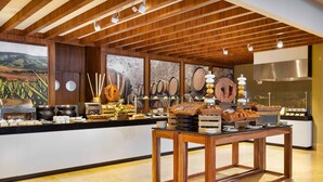A buffet area with wooden tables, a variety of food items, and a backdrop of wine barrels and a vineyard landscape. - Luxurious/comfortable 2-bdrm, 3 bath resort/spa in enchanting San Jose de Cabo (San Jose de Cabo)