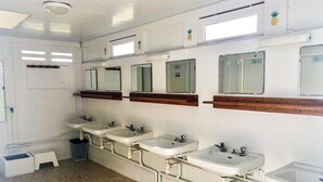 A public restroom with multiple sinks, mirrors, and a small step stool. - Lodging Nature Camp Crozon  (Lanveoc)