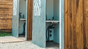 A row of portable restrooms with a simple design, each featuring a sink and a toilet. - Lodging Nature Camp Crozon  (Lanveoc)