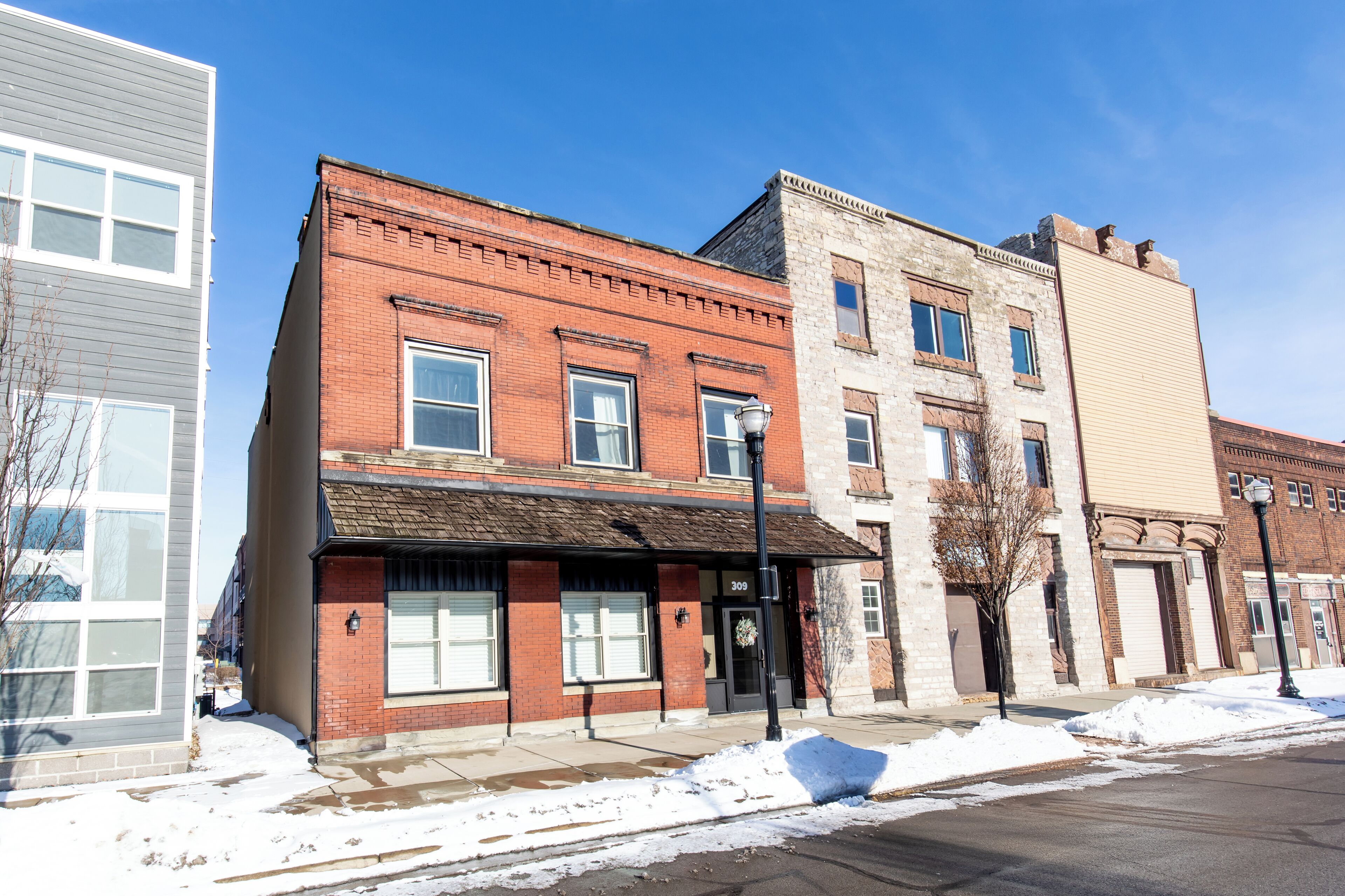 A multi-story building with a brick facade and a flat roof.