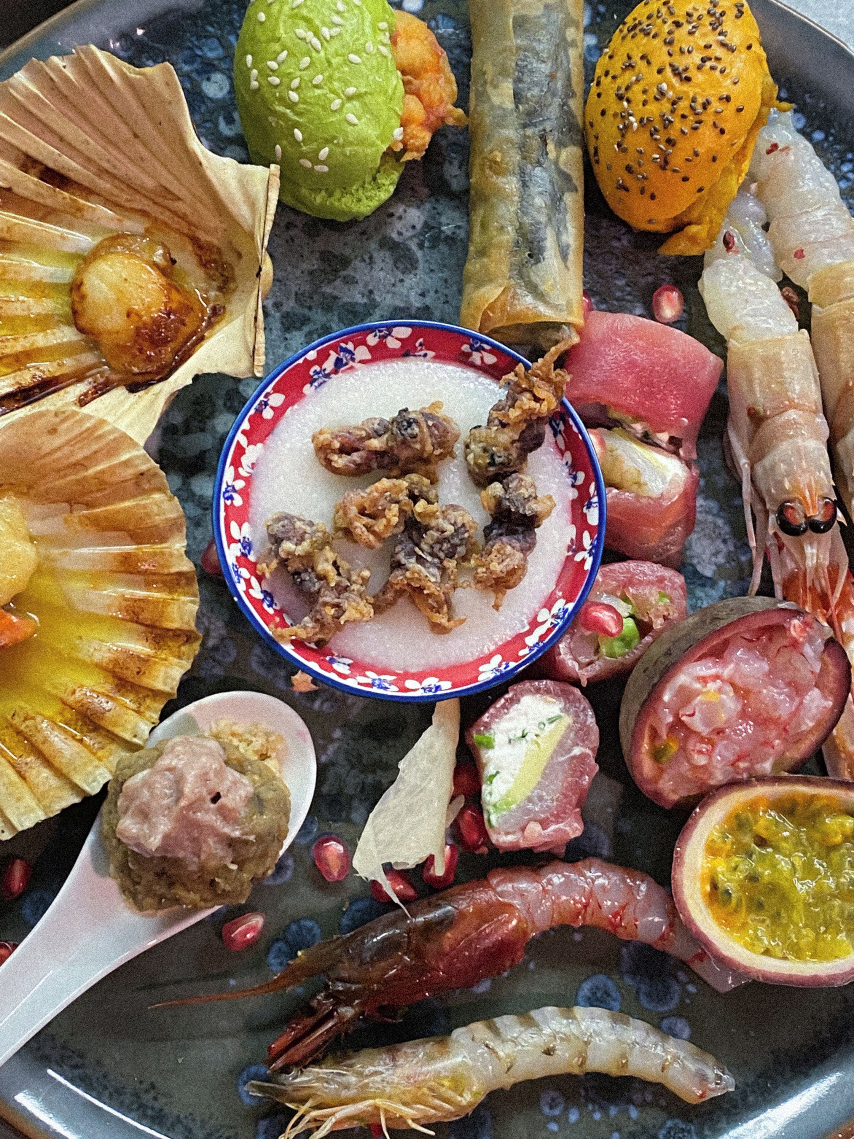 A variety of seafood and fruits arranged on a plate.