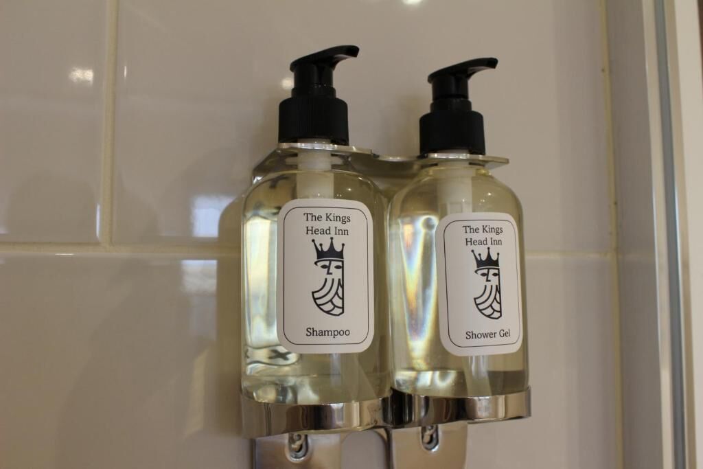 Two bottles of The Kings Head Inn shampoo and shower gel.