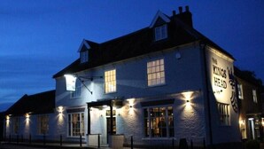A two-story building with a sign reading "The King's Head" at the corner. - The Kings Head Inn  (Norwich)