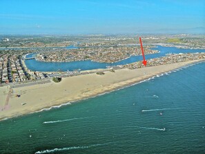 An aerial view of a coastal city with a beach, marina, and dense urban area. - Beachfront Estate - LB Peninsula (Long Beach)