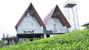 Un bâtiment à deux étages, doté d’un toit triangulaire et d’un balcon.