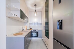 Family Apartment, Multiple Bedrooms (Modern Oasis With Terrace) | Private kitchen | Fridge, microwave, oven, stovetop