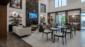 A spacious living area with a fireplace, comfortable seating, and a dining area with tables and chairs. - Beautiful 2BD/2BA Next to Airport 2888 (Del Valle)