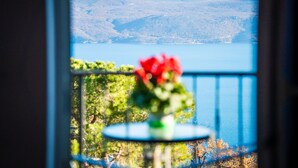 A balcony with a view of a lake and mountains.