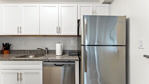 A kitchen with white cabinets, a stainless steel refrigerator, a granite countertop, and a dishwasher. - Beautiful 2bd/1.5ba near BU i31b (Boston)