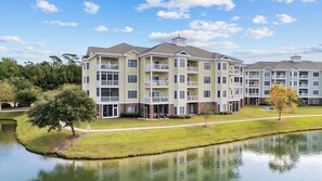 Stunning waterfront residence with a central entrance and spacious balconies.